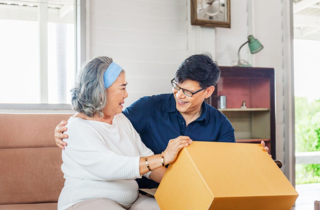 An adult child helping their older adult parent move into an assisted living community.