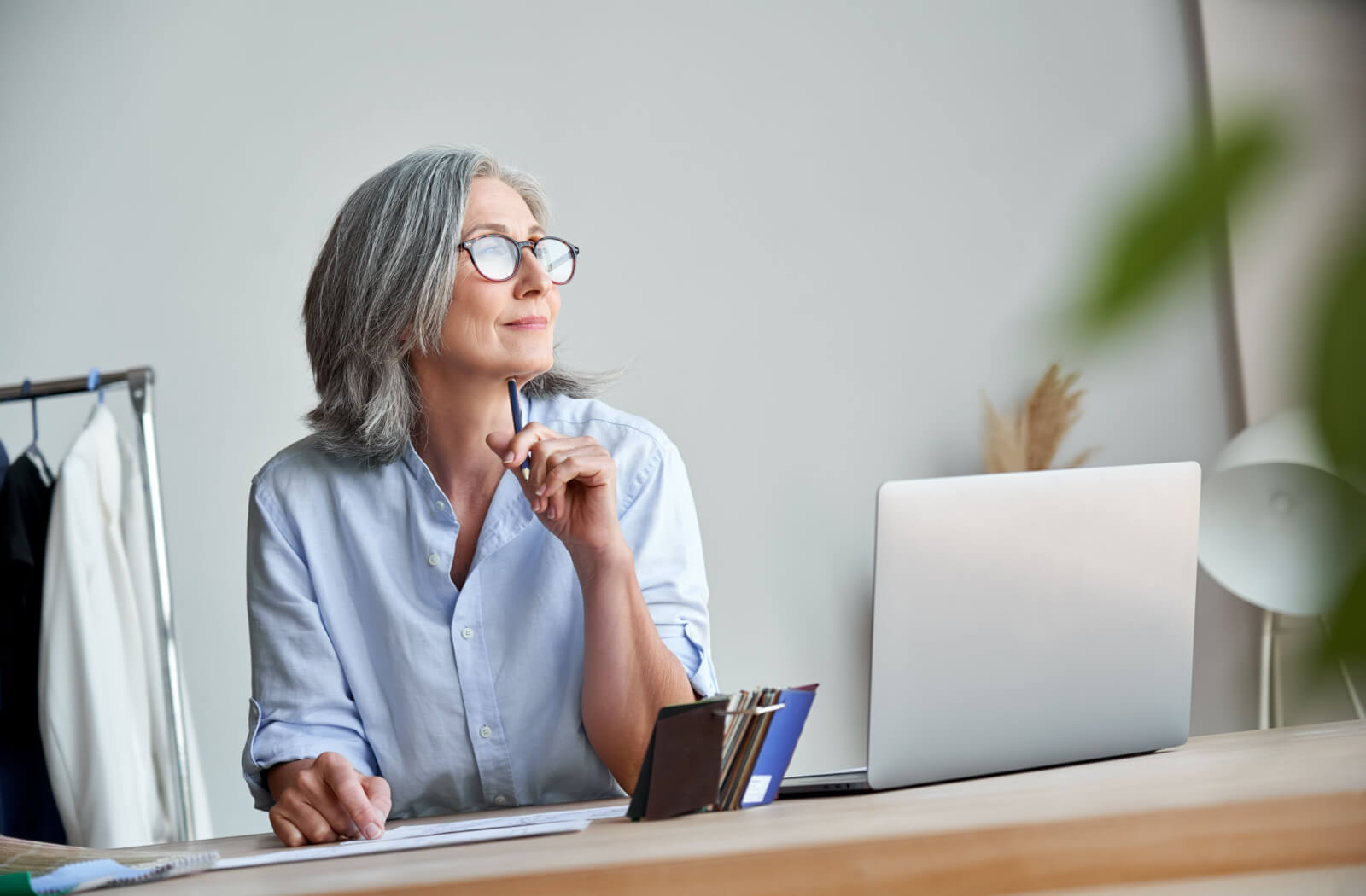 A senior woman pondering while she stares at a distance.